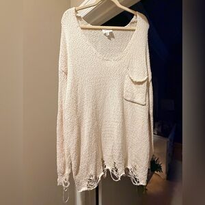 Elegant Cream V-Neck Sweater with Distressed Hem